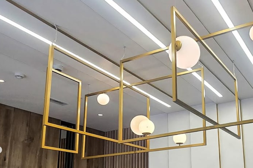 cluster of gold metal frames with opal glass diffusers